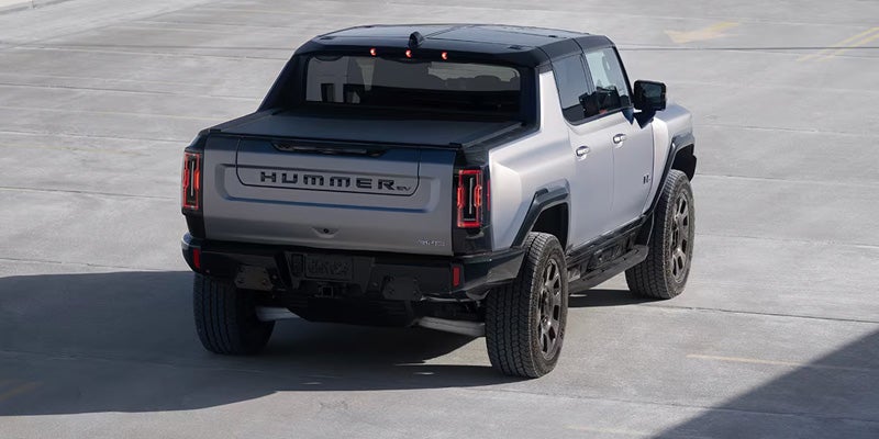 Used GMC Hummer EV driving on scenic highway