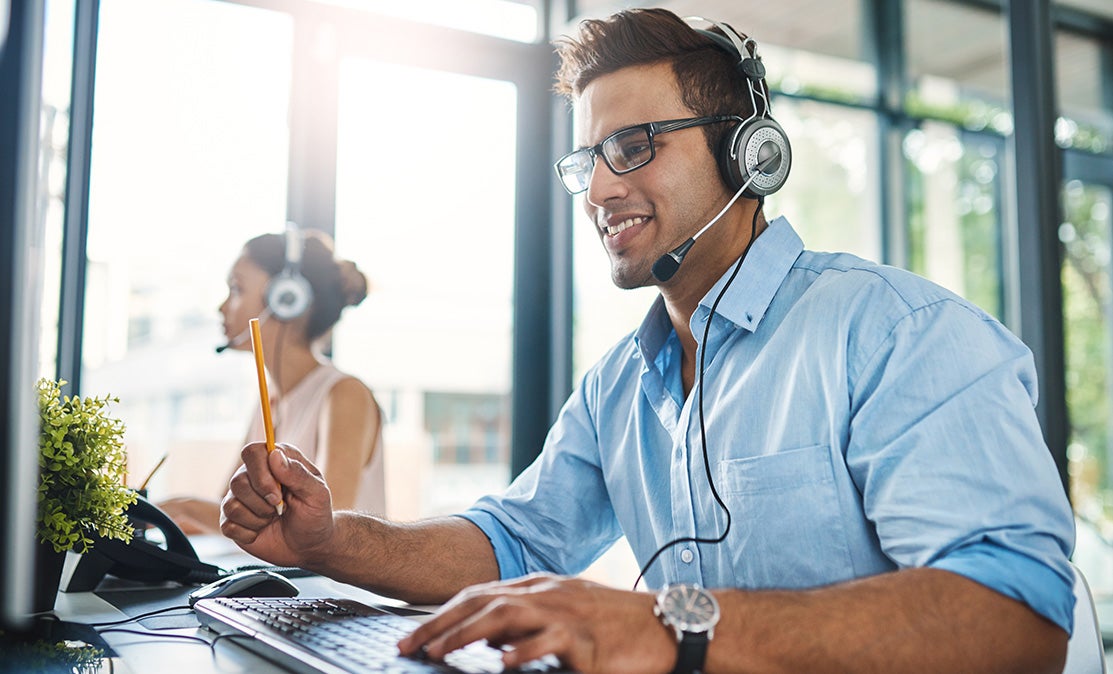 Customer support agent with a headset on a call